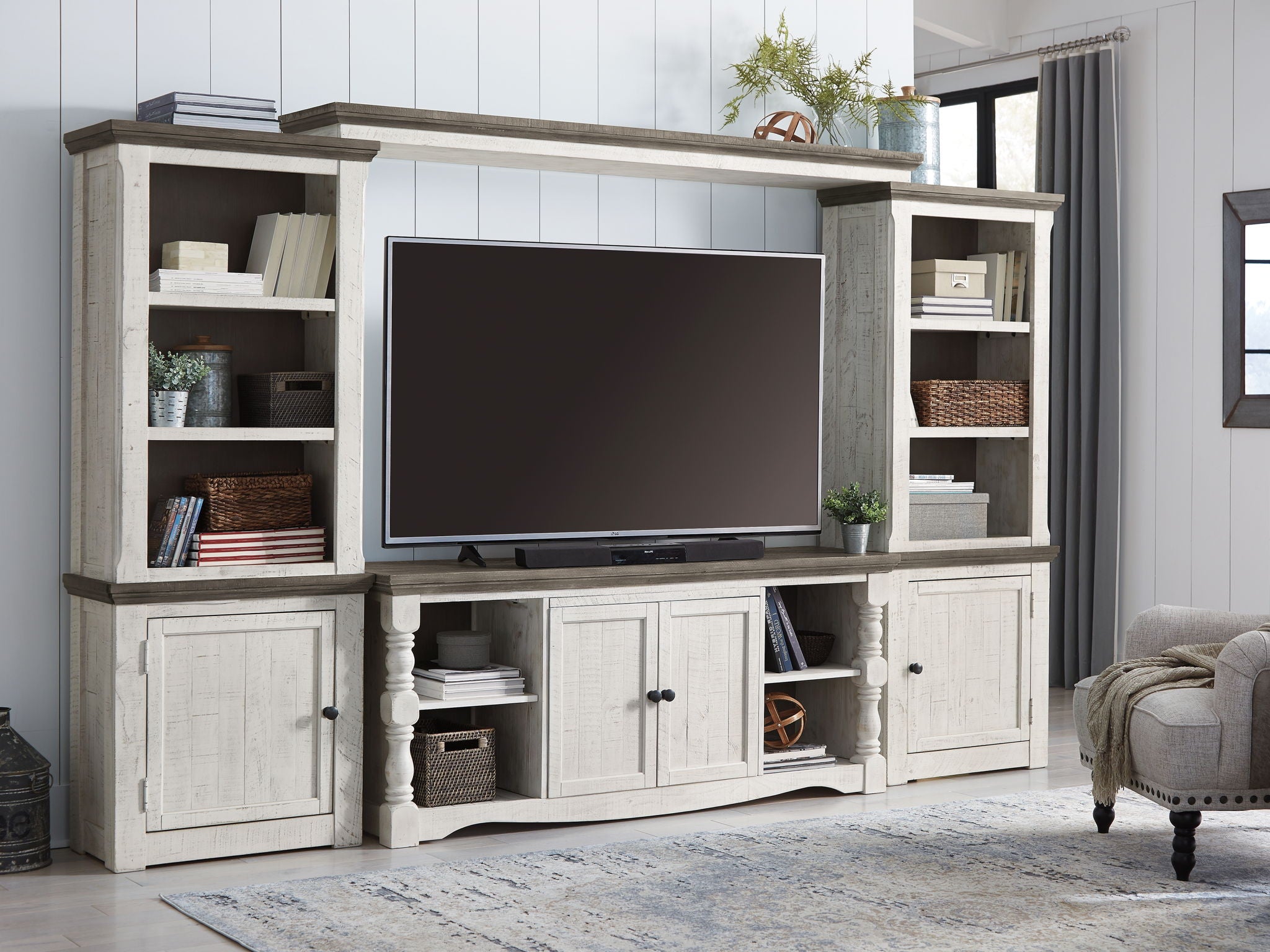 Entertainment center TV stand with open center shelving and side storage cabinets, whitewashed