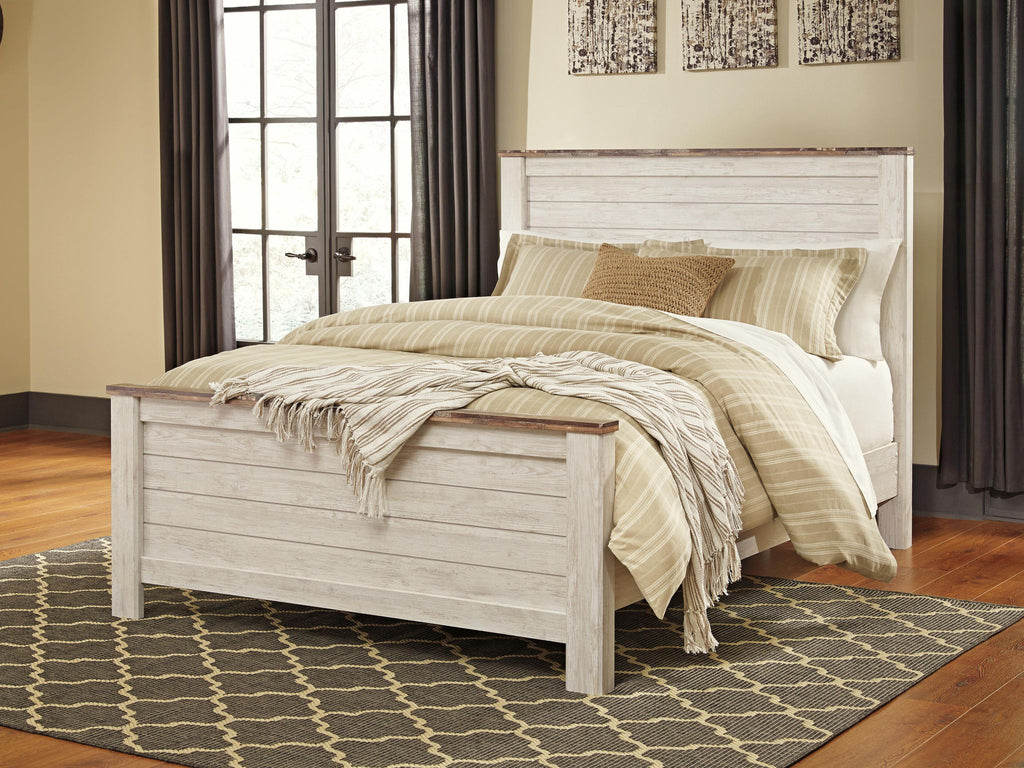 Beige panel bed with slatted panels and low footboard, striped bedding