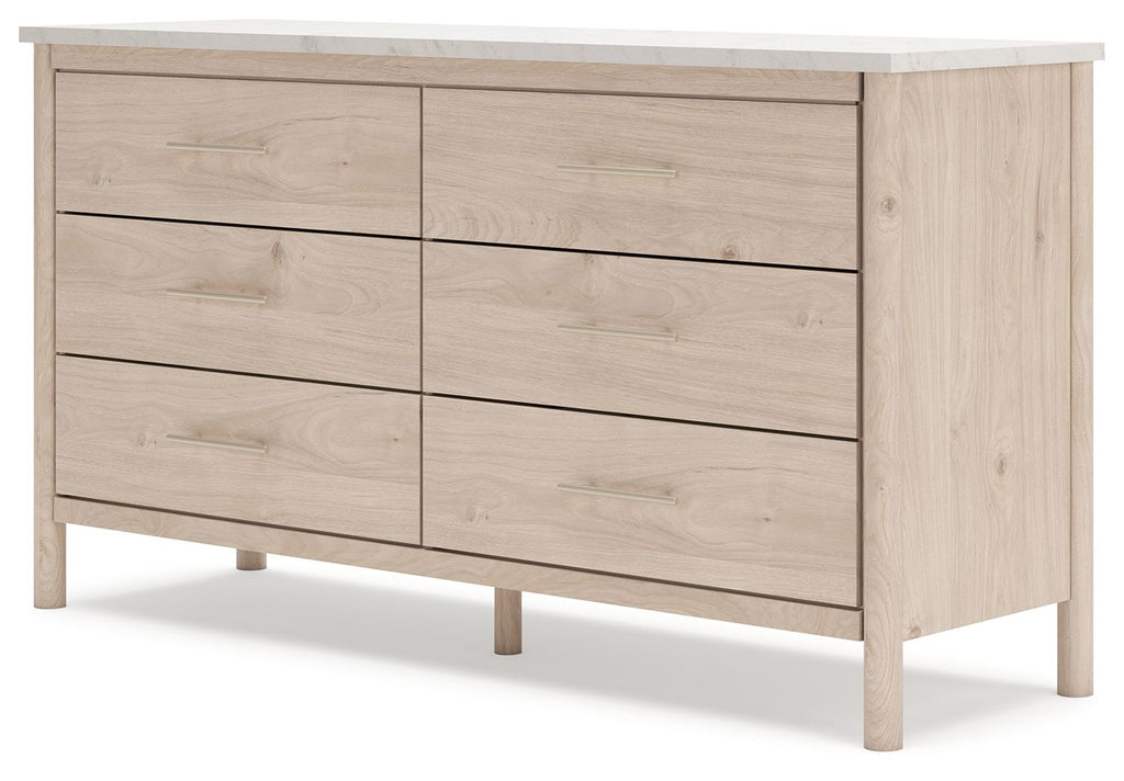 Light wood six-drawer dresser with six panel fronts and metal bar pulls, side view