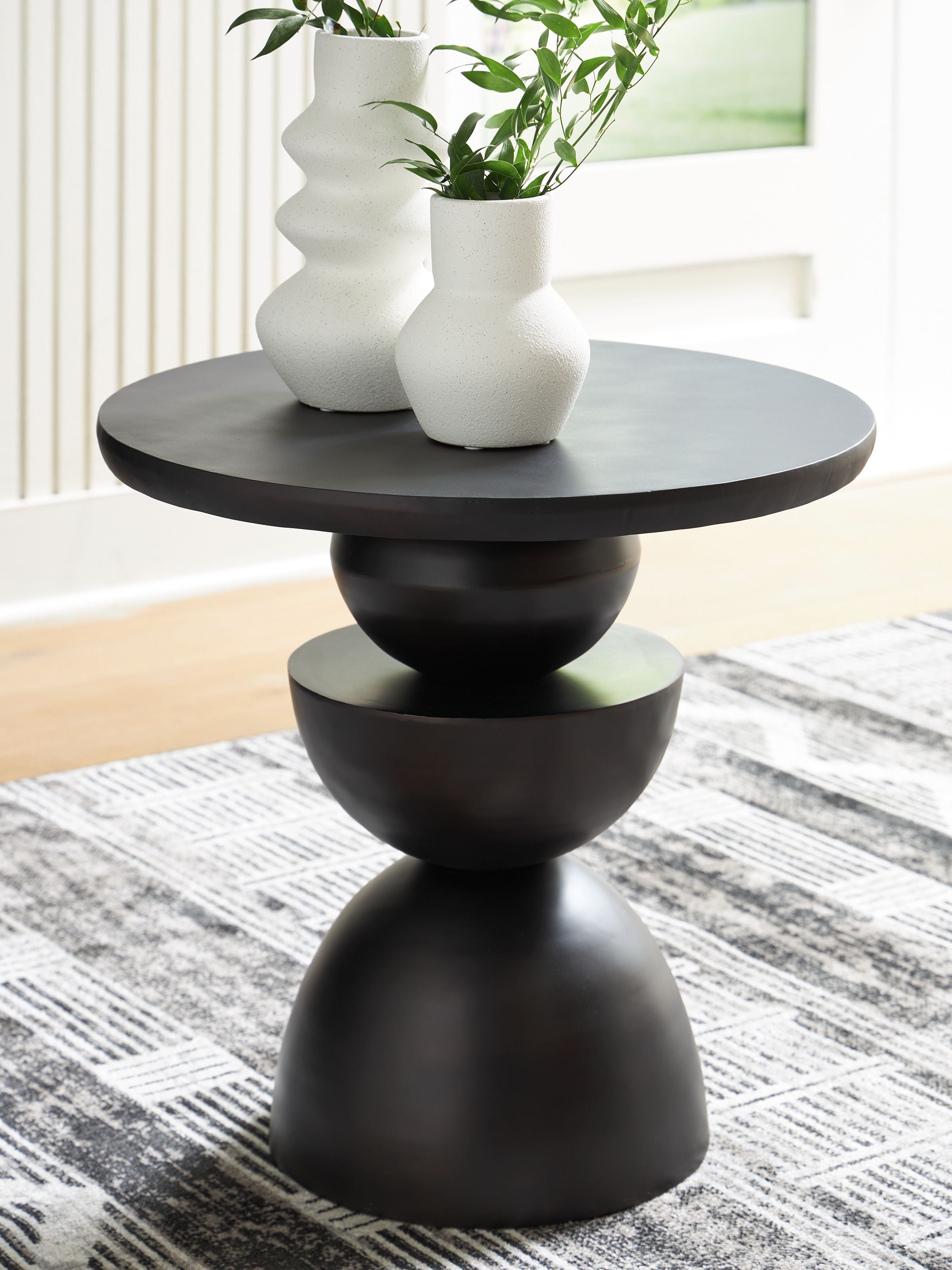 Bronze accent table with stacked hourglass legs and round tabletop, dark finish