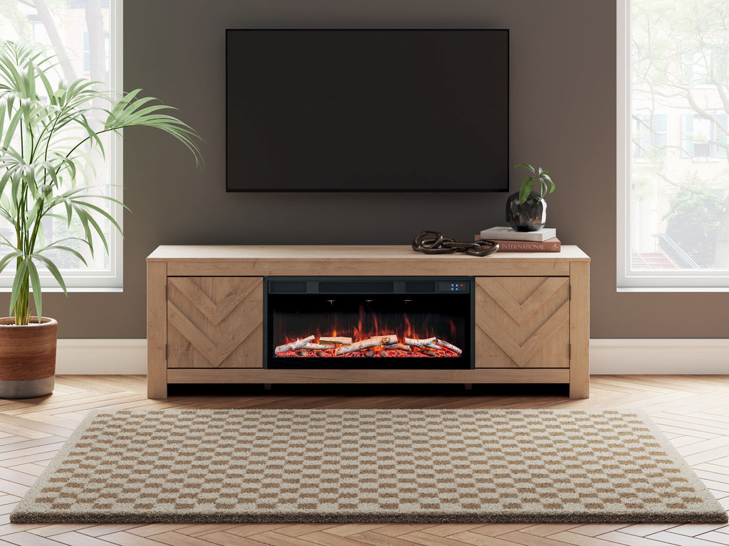 Light wood fireplace TV stand with burning fire display and central media opening
