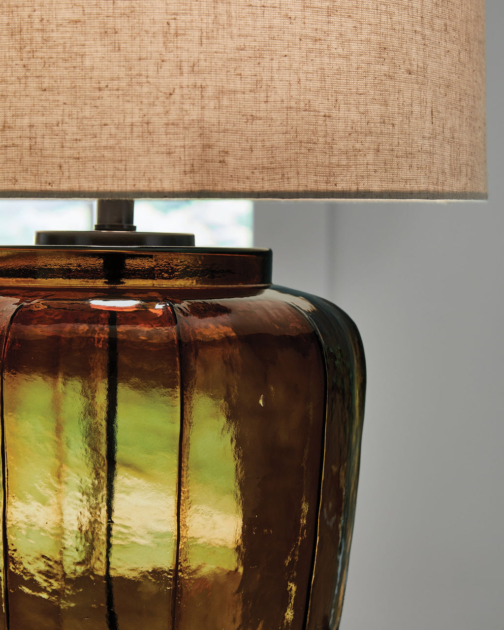 Amber glass table lamp base with ribbed pattern and black hardware