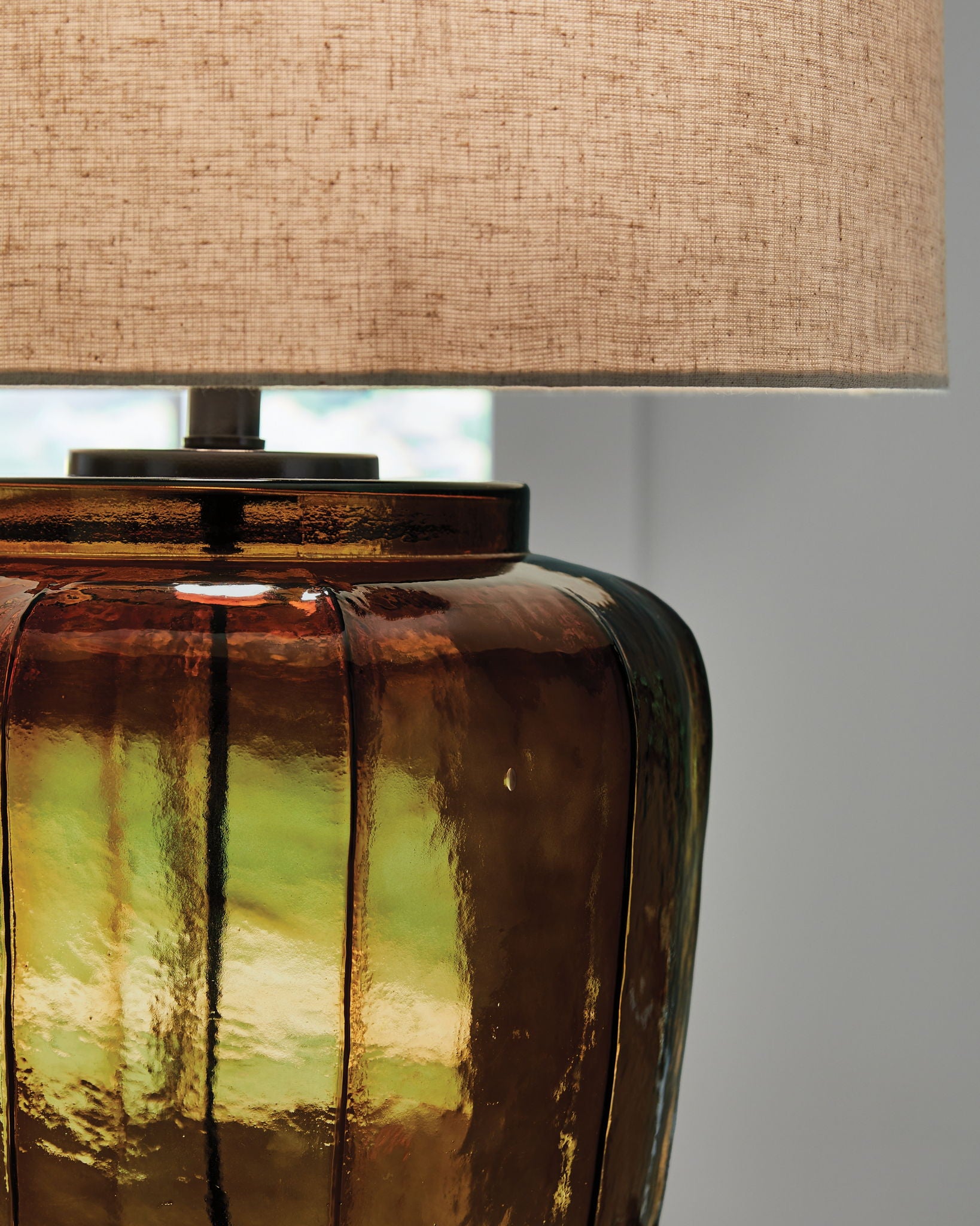 Amber glass table lamp base with ribbed pattern and black hardware