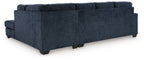 Dark navy fabric sectional sofa with chaise and tufted back cushion detail