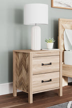 Two-drawer nightstand in light tan wood with black bar handles
