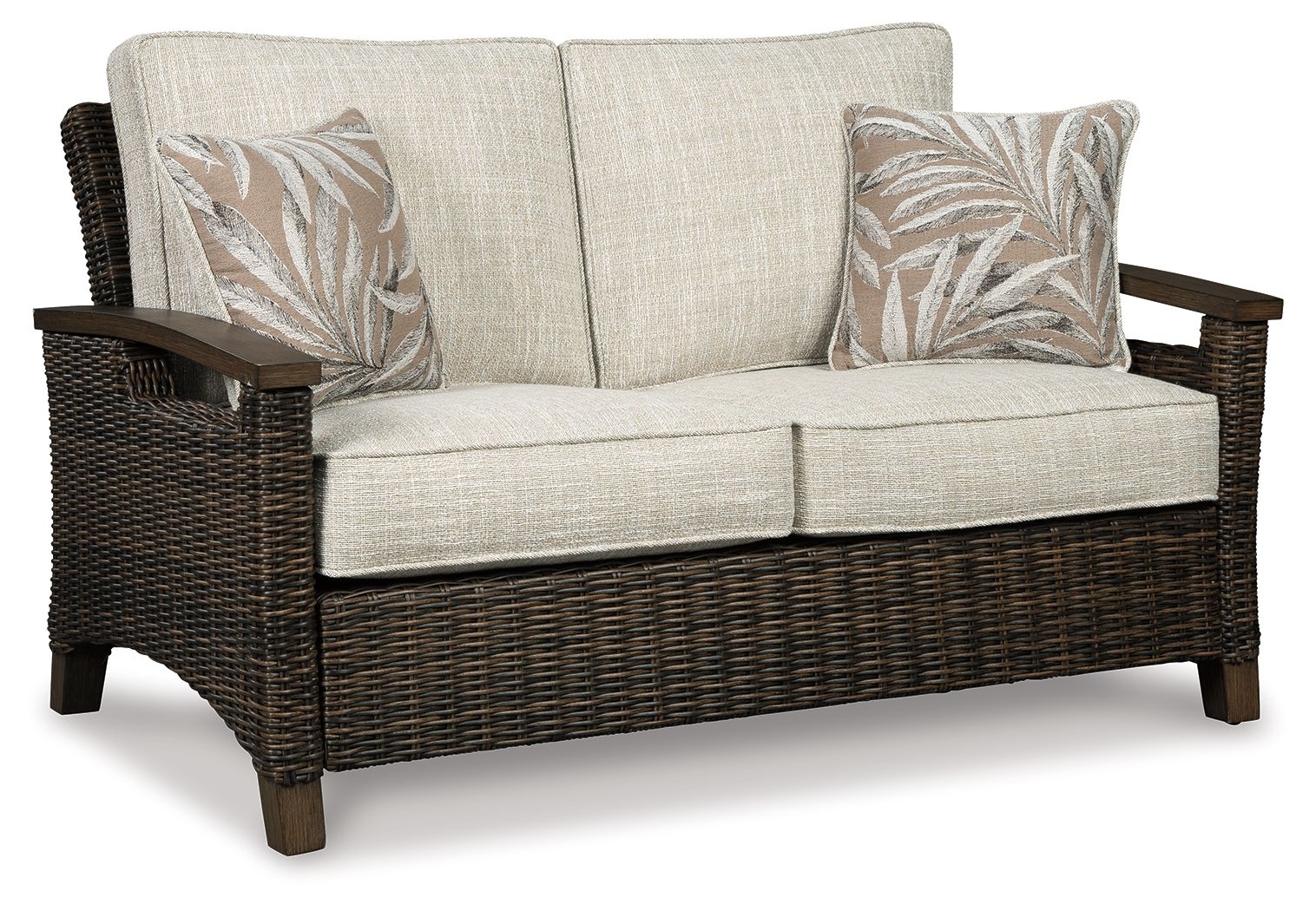 Loveseat with cushion, dark wicker arms, light beige seat and back, two leaf-print pillows