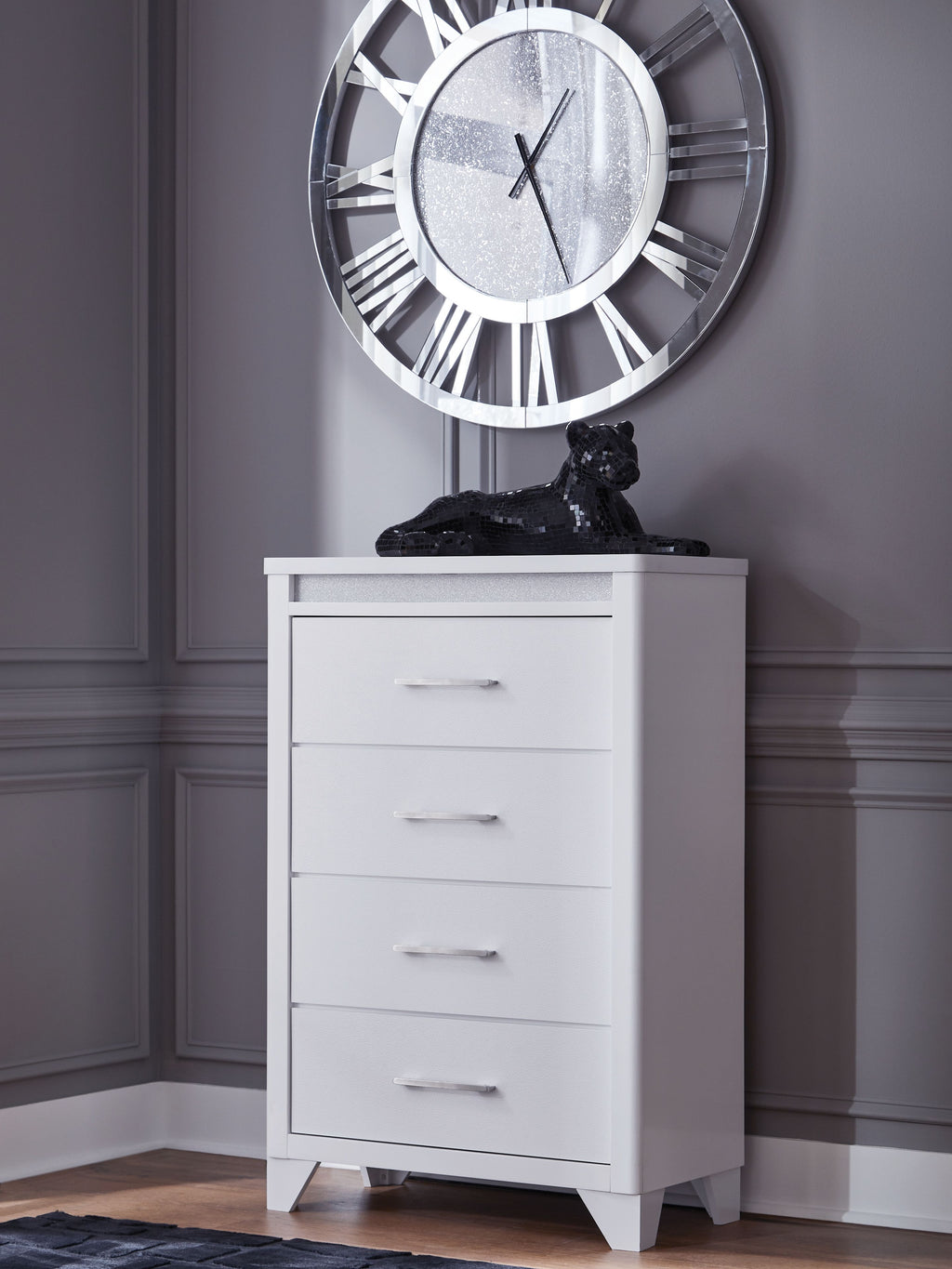 White four-drawer chest with metal bar handles and decorative textured top