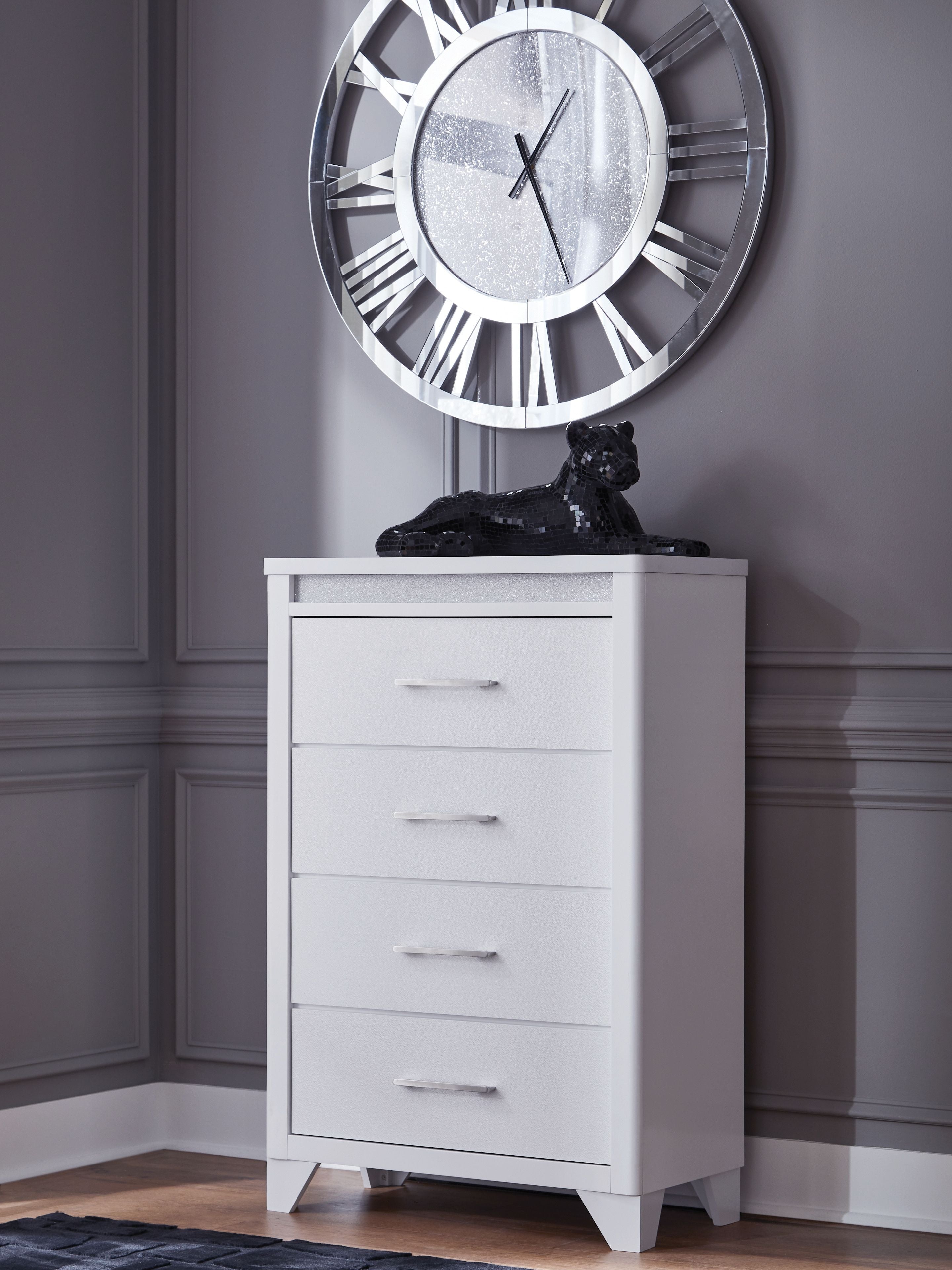 White four-drawer chest with metal bar handles and decorative textured top