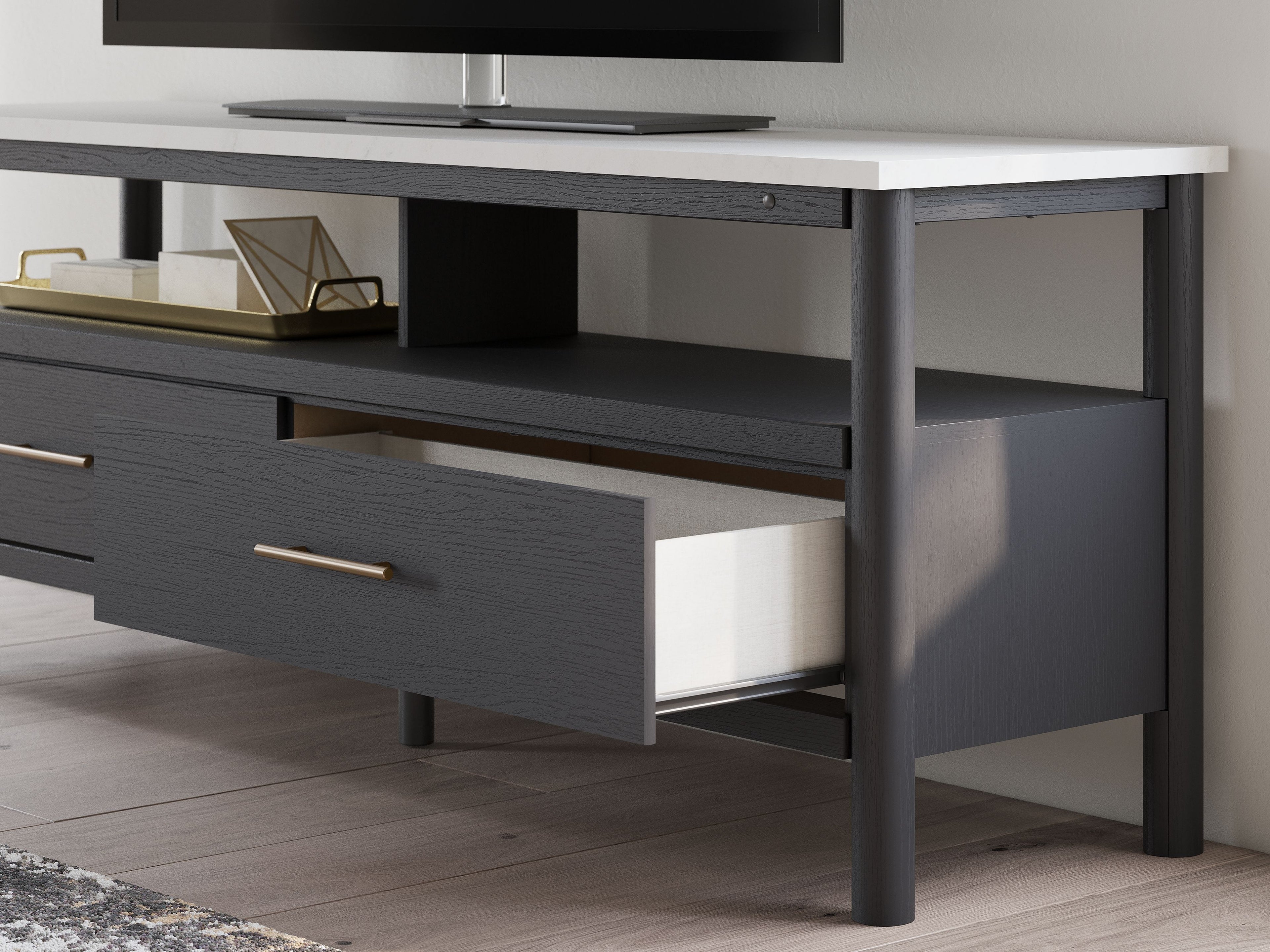Dark gray TV stand with drawers and open shelving for electronics