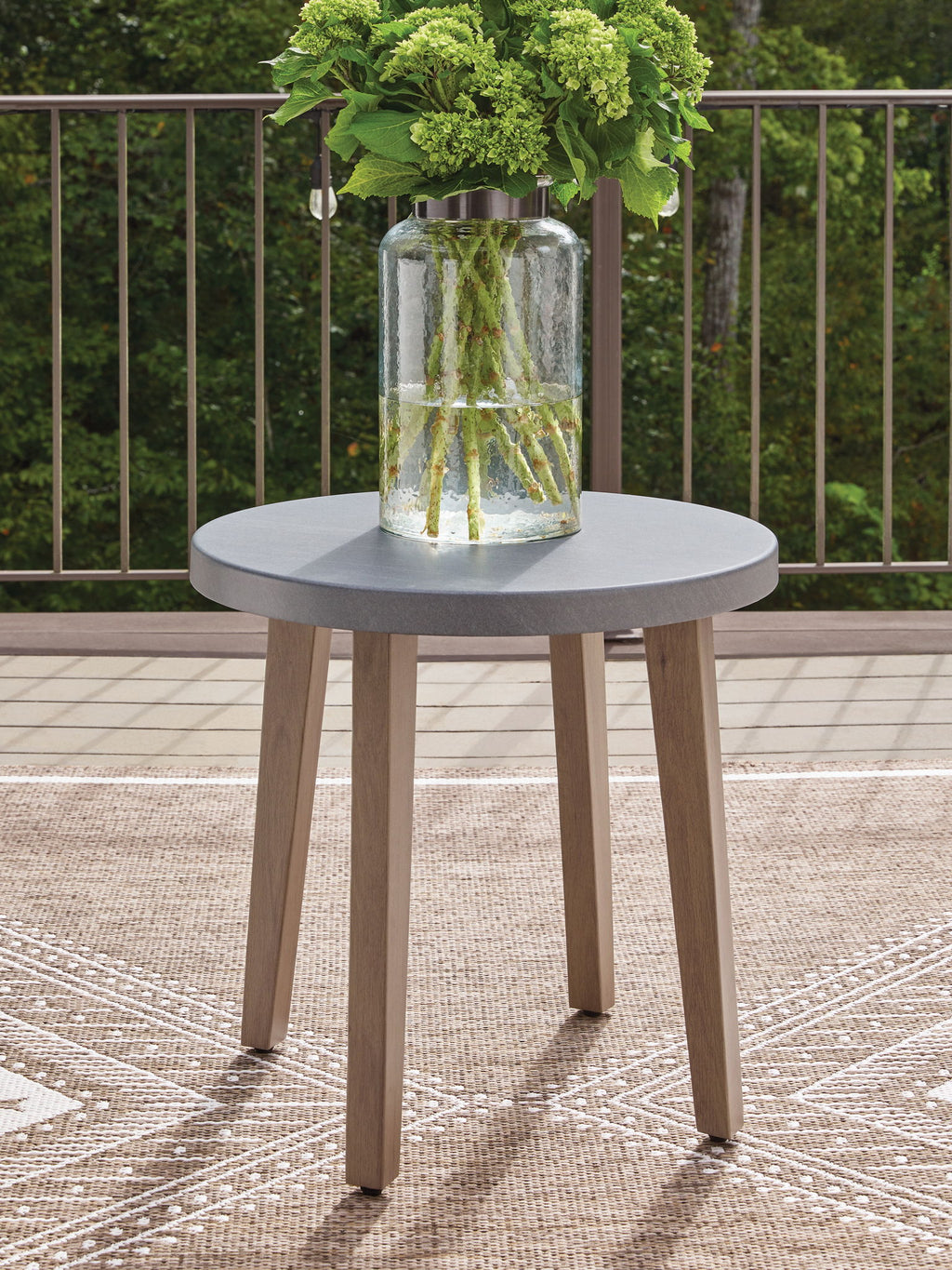 Round end table with gray round top, glass centerpiece, and natural wood legs