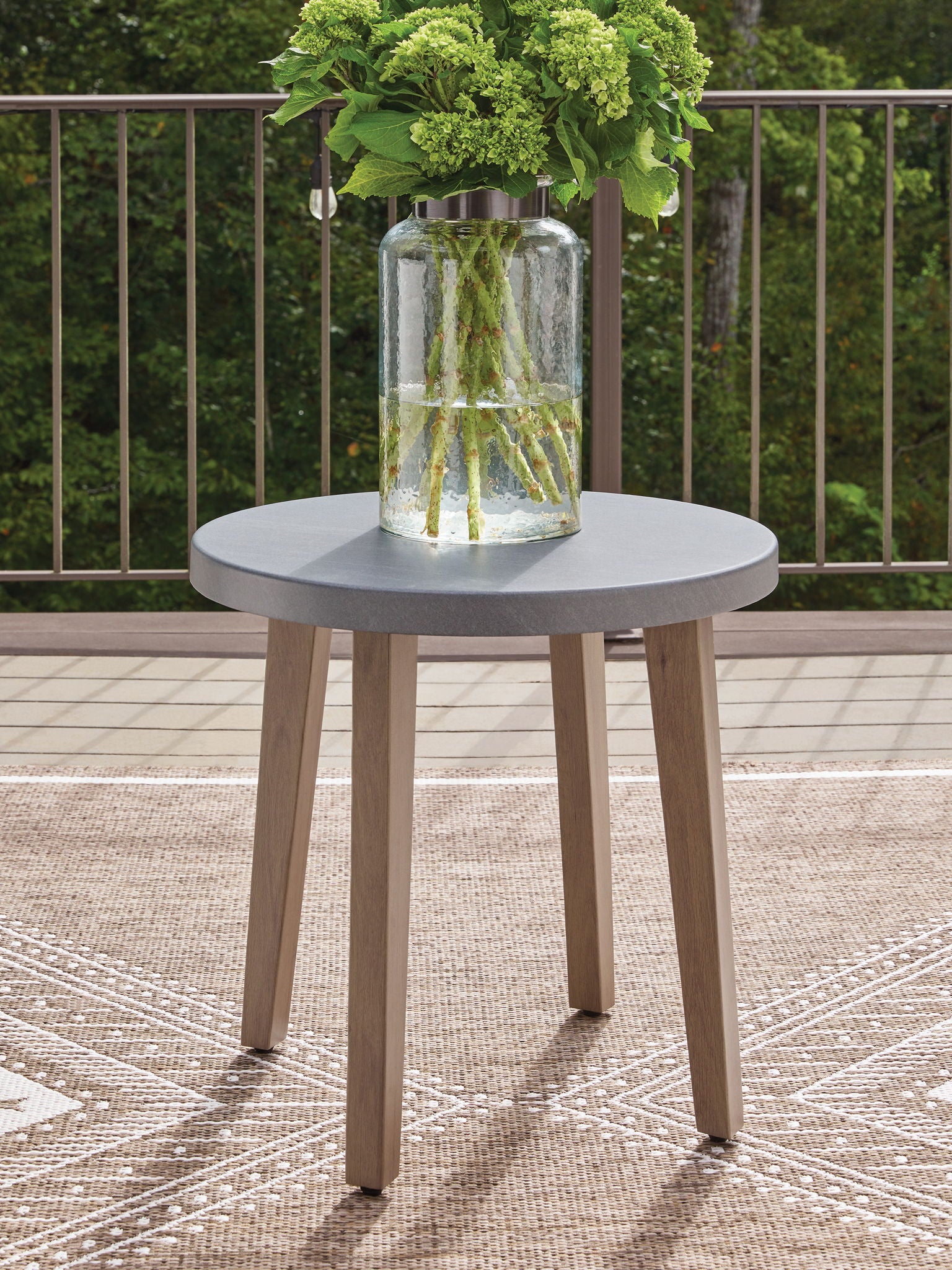 Round end table with gray round top, glass centerpiece, and natural wood legs