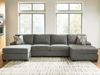 Gray sectional sofa with chaise, rounded seat cushions, and patterned accent pillows