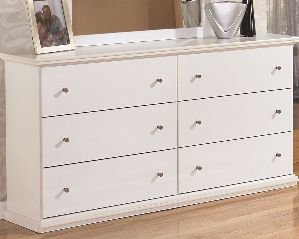 White dresser with six drawers and brass knobs, shown from front corner