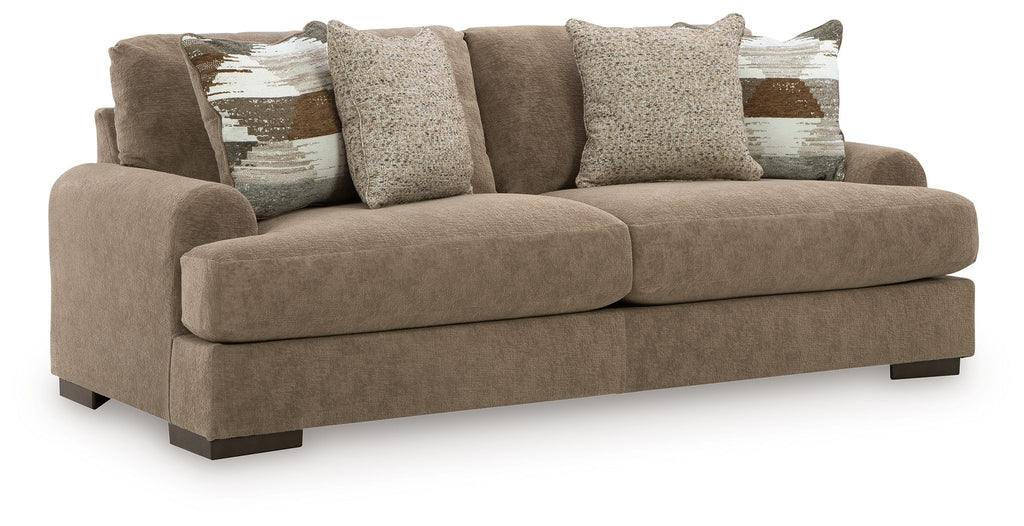 Brown sofa and loveseat set with patterned and textured throw pillows