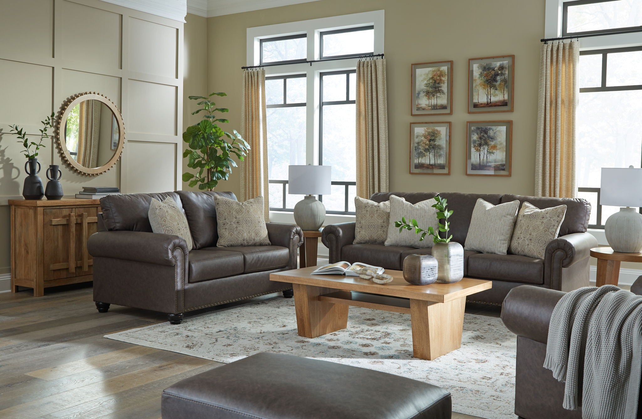 Dark brown upholstered living room seating set with sofa, chair, and ottoman.