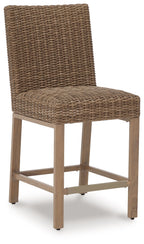 Woven bar stool with tall rectangular backrest, curved seat, and cross-style footrest