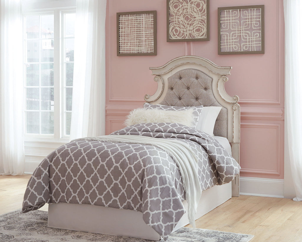 Twin upholstered headboard with button tufting in beige and chipped white carved frame