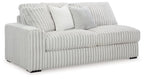 Light gray corded sofa with ribbed upholstery, rounded arms, and two accent cushions