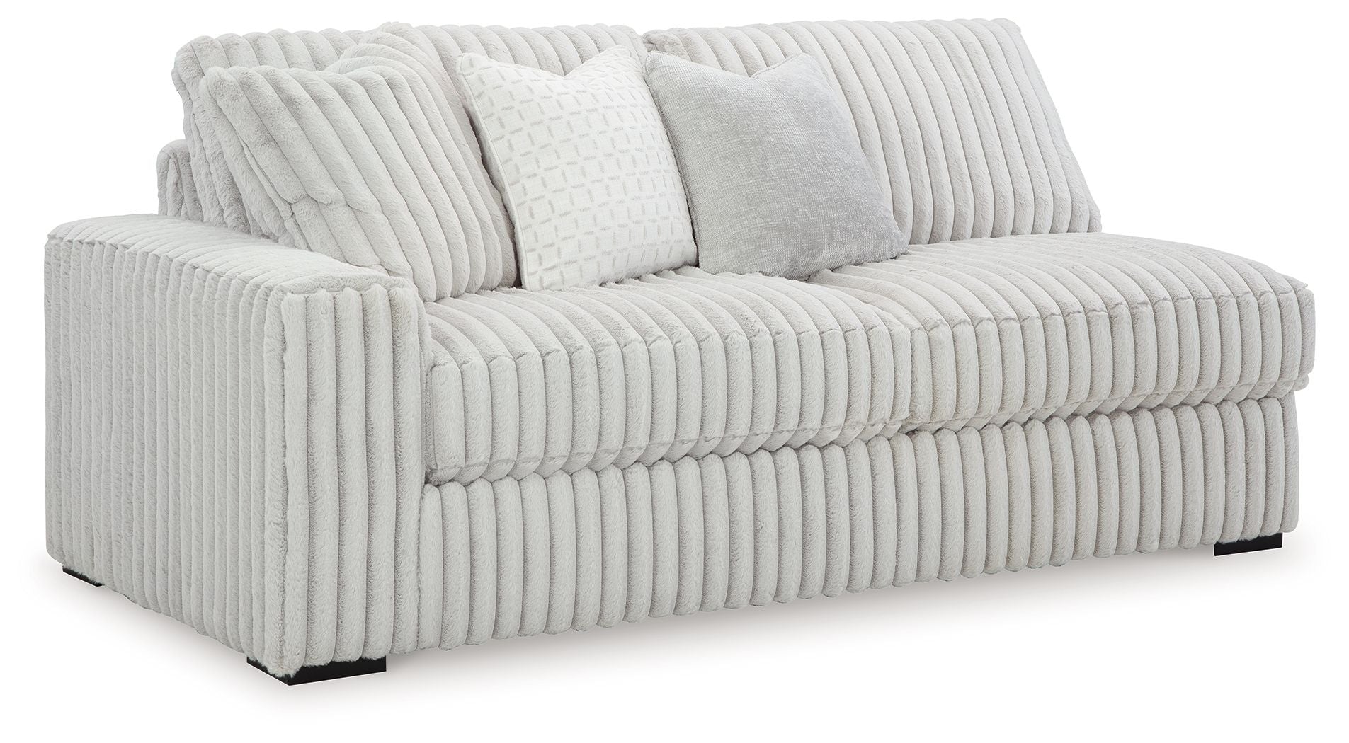 Light gray corded sofa with ribbed upholstery, rounded arms, and two accent cushions