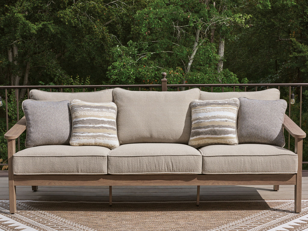 Outdoor sofa with cushions in natural beige, two gray arm cushions, four striped pillows
