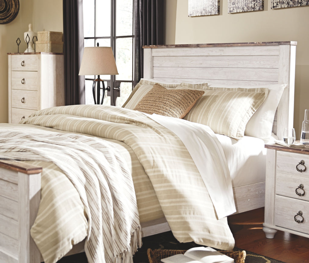 Panel bed with white frame and patterned bedding, with matching nightstand