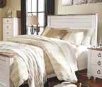 Panel bed with white frame and patterned bedding, with matching nightstand