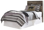 Dark gray bed with headboard, striped coverlet and patterned pillow