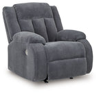 Fabric power rocker recliner, dark steel-gray upholstery, padded armrests and back