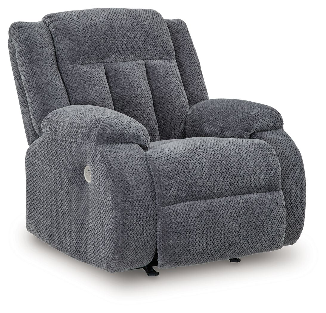 Fabric power rocker recliner, dark steel-gray upholstery, padded armrests and back