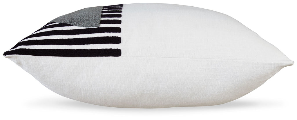 White pillow with black-and-white striped fabric patch on the corner