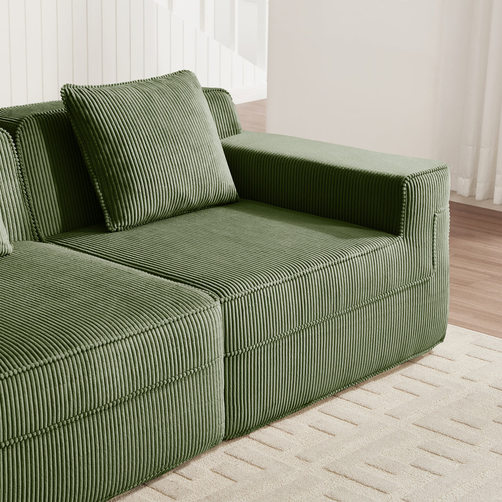 Green corduroy sectional sofa with square arms and striped upholstery, corner seat