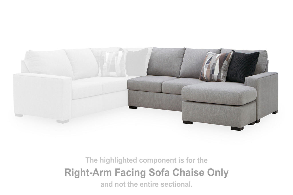 Two-tone sectional sofa chaise: white left seat and gray right ottoman with patterned pillows