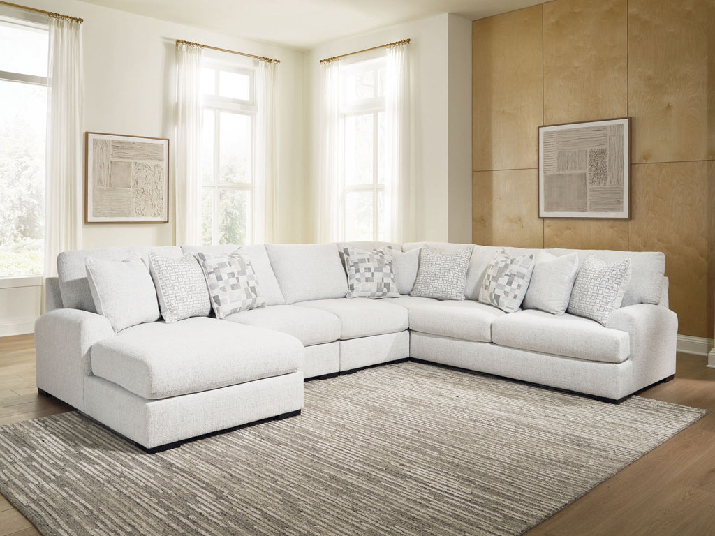 Light beige sectional sofa with chaise corner and multiple patterned throw pillows