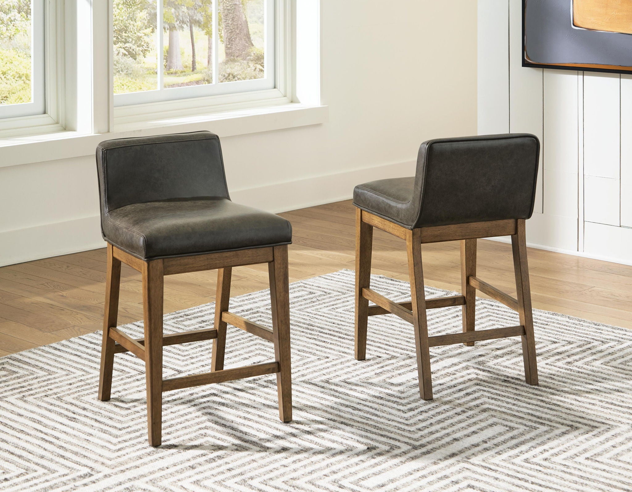 Set of two upholstered bar stools, dark brown seats and backs with light wood legs and footrests