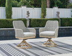 Pair of gray swivel patio chairs with white seat cushions and cross-brace base