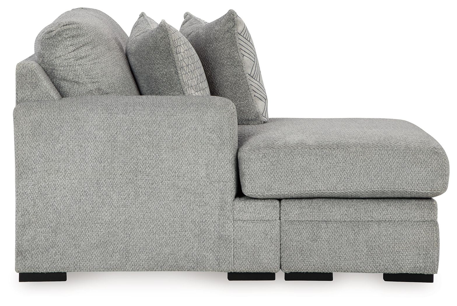 Gray sofa chaise with rounded armrest, chaise seat cushion, and stacked accent pillows