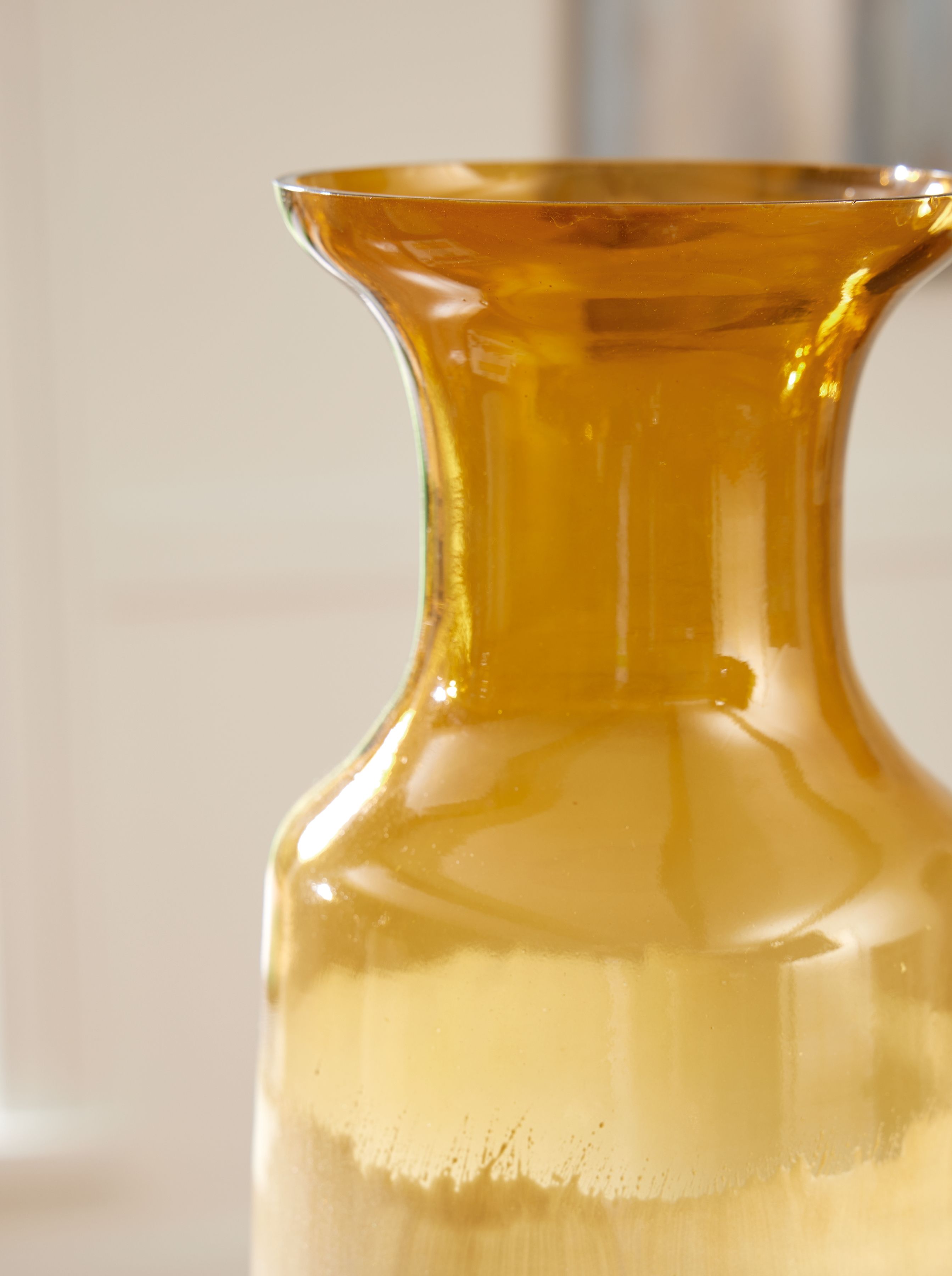 Amber glass vase with flared top, narrow neck, and ombre ivory base