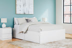 White platform bed with drawers, upholstered headboard, and white bedding