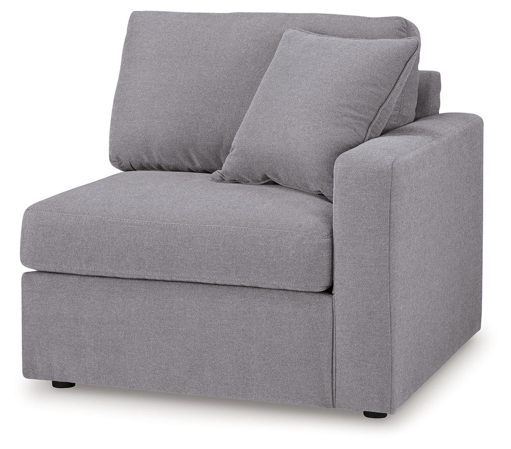 Heather gray upholstered corner chair with thick back cushions and squared right arm