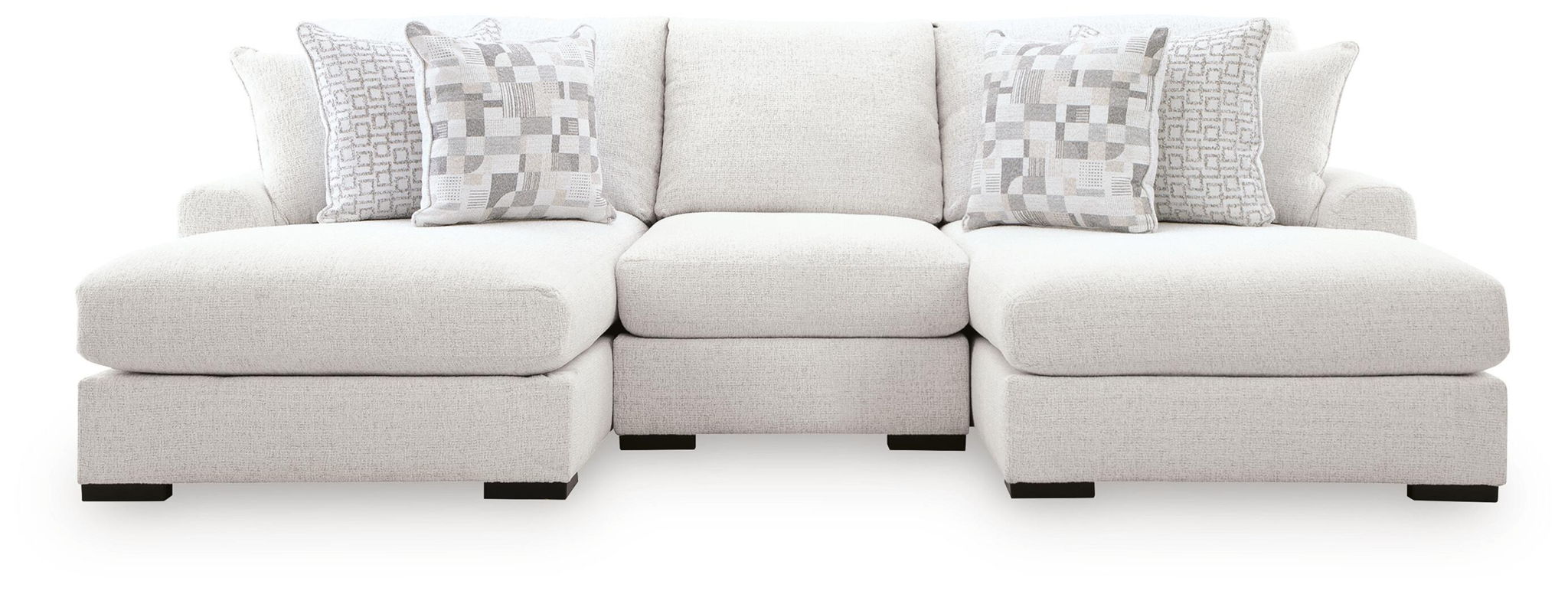 Off-white sectional sofa with three seat sections and chaise armrests, square pillows