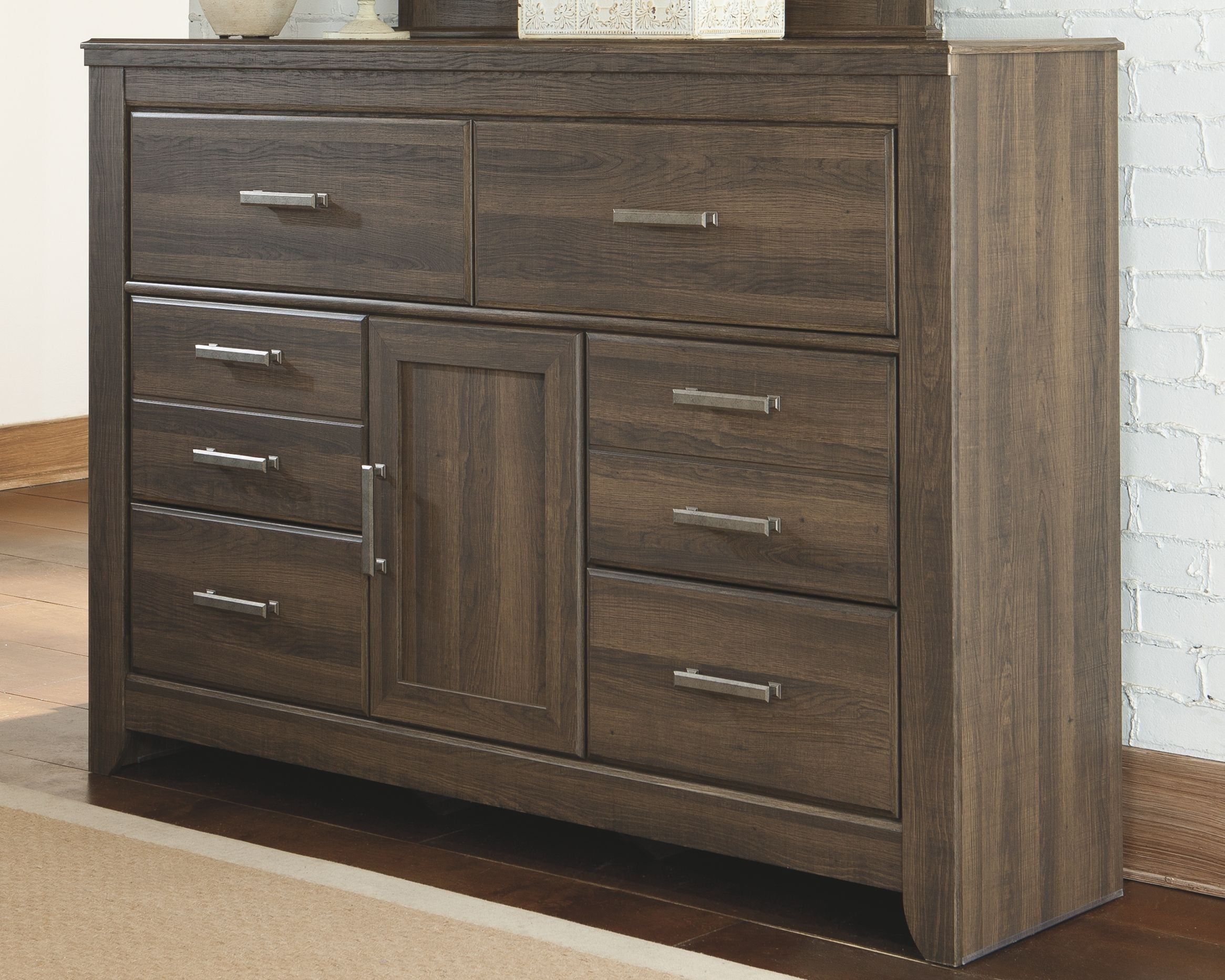 Dark brown wood dresser with central cabinet door, 5 drawers, and metal bar pulls