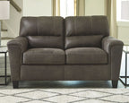 Smoke gray two-seat loveseat with tufted back cushions, padded arms, and dark legs