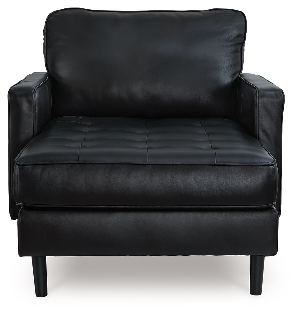 Onyx black leather chaise chair with deep seat cushions and rolled back, tapered legs