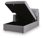 Gray chaise with lift-top storage compartment and hinged lid panel