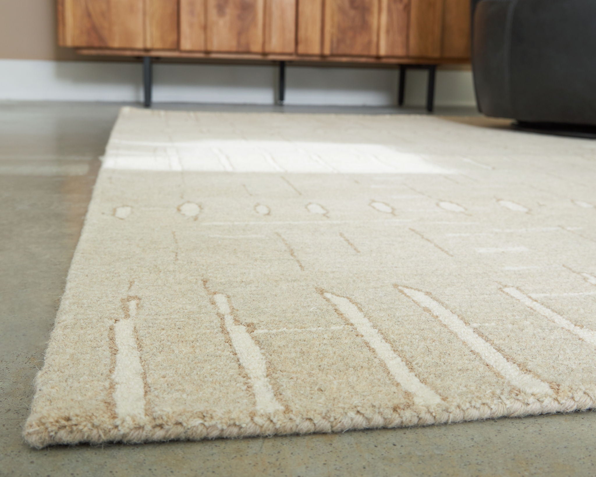 Light brown rug with abstract linear pattern