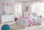 White sleigh bed headboard with floral bedding and purple throw on a bed frame