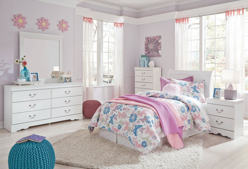 White sleigh bed headboard with floral bedding and purple throw on a bed frame