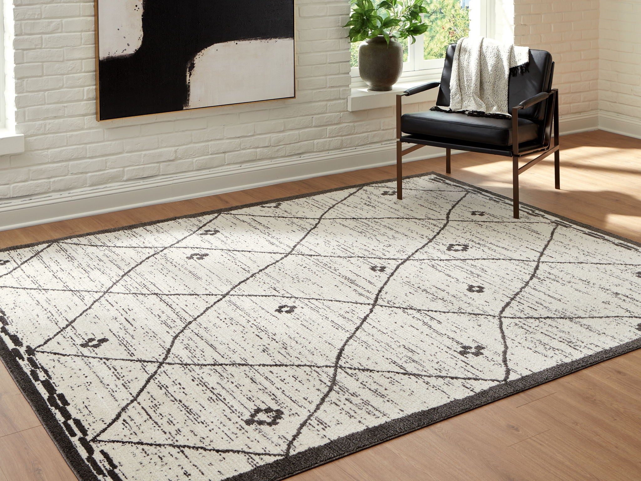 Beige and black geometric area rug with curved grid lines and dark edging