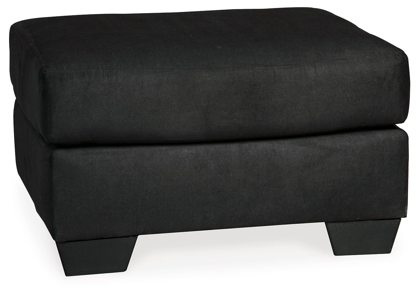 Black upholstered ottoman with rounded top cushion and short dark legs.