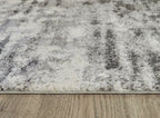 Pearl silver shag rug with distressed abstract pattern and low pile edge